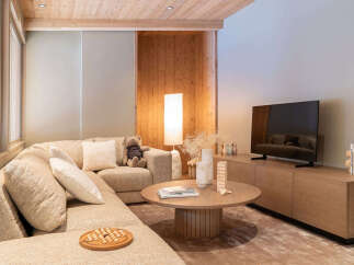 Experience ultimate relaxation in this cozy living room, featuring a plush sectional sofa perfect for family gatherings.