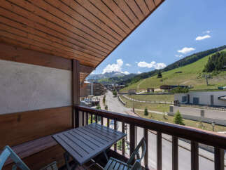 Enjoy breathtaking mountain views from this charming balcony, complete with a table and chairs for al fresco dining.