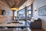 Experience cozy mountain living in this charming alpine retreat, featuring a rustic wooden interior and breathtaking panoramic views of snow-capped peaks.