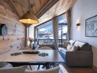 Experience cozy mountain living in this charming alpine retreat, featuring a rustic wooden interior and breathtaking panoramic views of snow-capped peaks.
