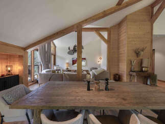 Experience rustic luxury in this stunning mountain retreat, featuring a grand wooden dining table perfect for gatherings.