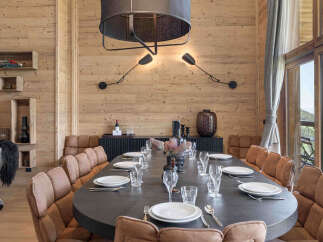Experience luxurious mountain living in this stunning dining room, featuring a grand oval table perfect for hosting.