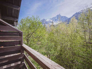 Experience breathtaking mountain views from this charming wooden balcony, perfect for enjoying your morning coffee or evening relaxation.