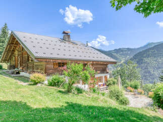 Experience the charm of this rustic wooden chalet nestled in a breathtaking mountain landscape.