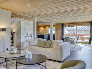 Experience luxurious mountain living in this stunning open-concept living space, featuring a cozy sectional sofa and a modern dining area perfect for entertaining.