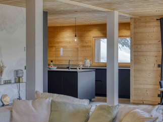 Experience modern mountain living in this stunning open-plan kitchen and living area.