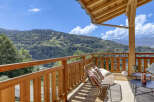 Enjoy breathtaking mountain views from this charming wooden balcony, perfect for relaxing or entertaining.