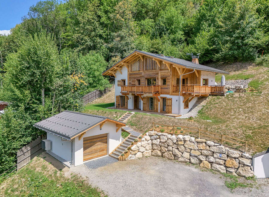 Experience luxury mountain living in this stunning chalet, nestled amidst lush greenery.