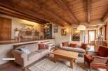Step into a charming living space featuring a raised dining area with a table and chairs, perfect for intimate meals.