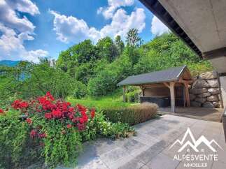 Discover this stunning property featuring a beautiful garden with vibrant red roses and lush greenery, perfect for outdoor relaxation.