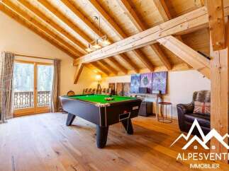 Experience luxury mountain living in this stunning chalet featuring a spacious game room with a professional billiard table.