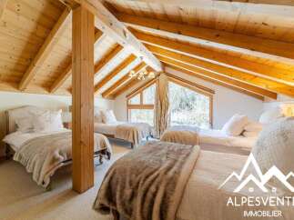 Discover this charming attic bedroom featuring multiple beds, perfect for accommodating family or guests.