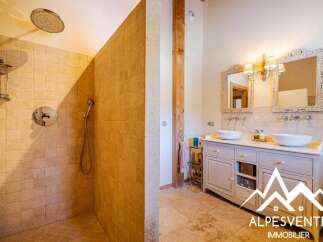 Experience luxury in this stunning bathroom featuring a spacious walk-in shower with elegant tilework and a rainfall showerhead.