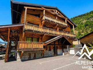 Experience luxury mountain living in this stunning wooden chalet, featuring multiple balconies with breathtaking views and a charming stone base.