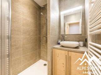 Experience modern comfort in this beautifully appointed bathroom, featuring a spacious walk-in shower with elegant tiling.