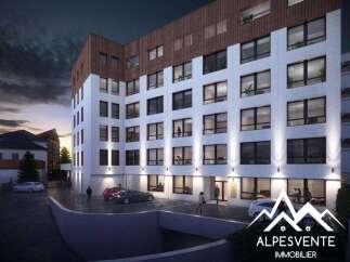 Discover modern living in this stunning apartment building, featuring a striking facade with a mix of white and wood-paneled elements.