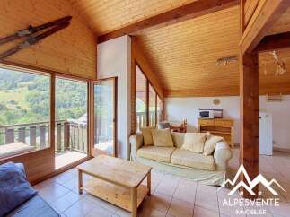Experience mountain living in this charming chalet-style living room, featuring a cozy sofa and a rustic wooden coffee table.