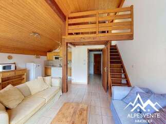 Discover this charming mountain retreat featuring a cozy living area with ample natural light and a functional kitchenette.