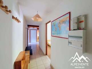 Discover this charming hallway featuring a world map and a practical electrical panel.
