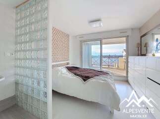 Experience modern living in this bright bedroom featuring a comfortable bed with a plush duvet and a stylish headboard.