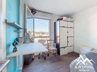 Discover this charming room featuring a functional desk area with a globe and lamp, perfect for work or study.
