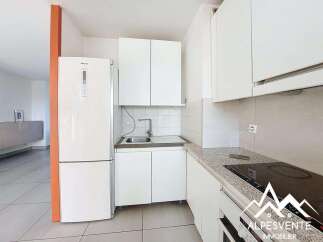 Discover this charming kitchen featuring a sleek white refrigerator and ample cabinet space for all your storage needs.