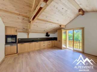 Experience modern alpine living in this beautifully appointed kitchen, featuring sleek wooden cabinetry and a built-in oven and dishwasher.