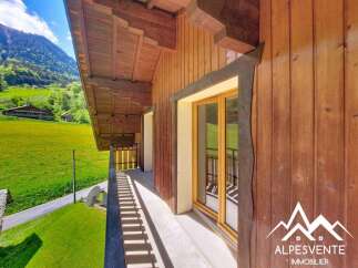 Experience breathtaking mountain views from this charming wooden chalet, featuring a spacious balcony perfect for enjoying the alpine scenery.
