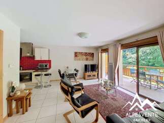Experience comfortable living in this inviting apartment, featuring a modern kitchen with red tile backsplash and bar seating.