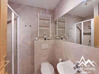 This modern bathroom features a sleek shower enclosure and a convenient heated towel rack, perfect for a comfortable stay.