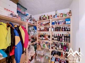 Discover ample storage solutions in this property, featuring a well-organized pantry with multiple shelves stocked with food items and beverages.