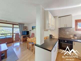 Enjoy stunning mountain views from this charming apartment, featuring a bright and airy living space with a dining area perfect for family meals.