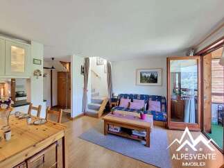Discover this charming apartment featuring a cozy living area with a sofa bed and a coffee table, perfect for relaxation.