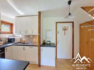 Discover this charming kitchen featuring crisp white cabinetry and a practical countertop space.