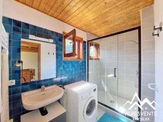 Discover this charming bathroom featuring a sleek shower enclosure with glass doors and modern fixtures.