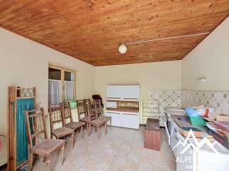 Discover this charming room featuring a rustic wooden ceiling and ample natural light from the large window.