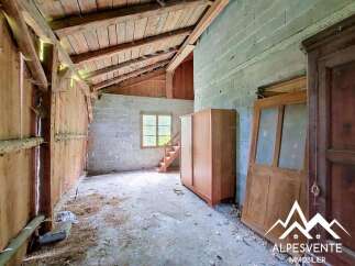 Discover this rustic interior space with exposed wooden beams and a pitched ceiling, offering a unique architectural charm.