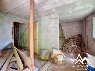 This rustic interior space features exposed concrete ceilings and cinder block walls, hinting at a renovation project.