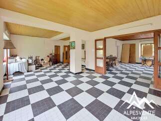 Discover a spacious and versatile interior featuring a striking black and white checkered floor that adds a unique character to the home.
