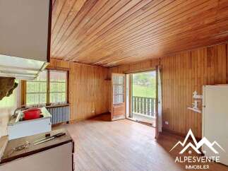 Experience rustic charm in this cozy room featuring warm wooden paneling on the walls and ceiling.