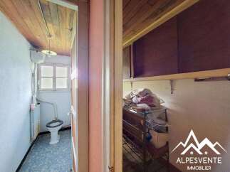 Discover this charming property featuring a functional bathroom with a toilet and radiator, perfect for a cozy mountain retreat.