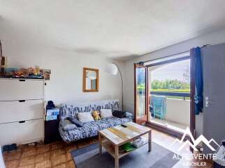 Bright and airy living room featuring a comfortable sofa bed adorned with city-themed upholstery and plush cushions.