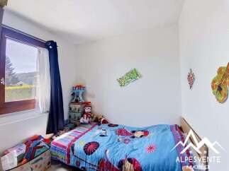 This charming child's bedroom features a cozy bed adorned with a vibrant blue comforter, perfect for little ones.