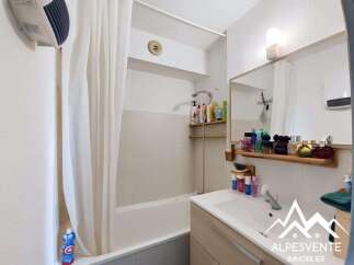 Discover this charming bathroom featuring a bathtub with a shower curtain, perfect for relaxation.