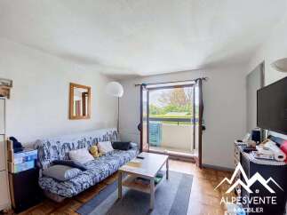 Bright and airy living room featuring a comfortable sofa bed adorned with a city skyline pattern, perfect for relaxing or accommodating guests.