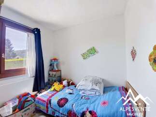 This charming child's bedroom features a cozy bed with vibrant blue bedding, perfect for a good night's sleep.