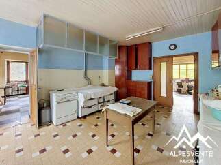 Discover this charming kitchen featuring classic wooden cabinetry and a functional gas stove, perfect for home cooking.