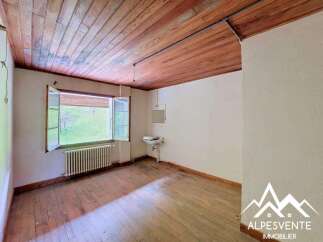 This charming room features a beautiful wooden ceiling and original hardwood floors, creating a warm and inviting atmosphere.