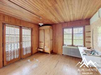 This charming room features rustic wooden walls and ceiling, creating a warm and inviting atmosphere.