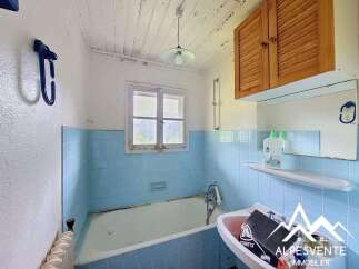 This charming bathroom features a classic clawfoot bathtub and a vintage sink, perfect for a relaxing soak.